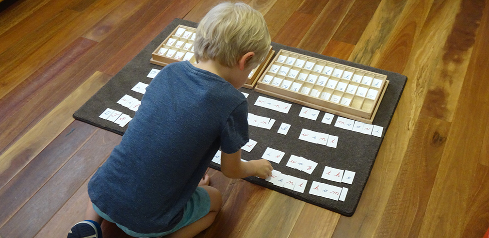 Writing with small moveable letters, the Montessori way.